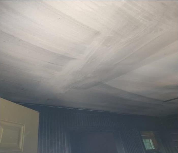 Ceiling stained with soot after dry cleaning and before painting.