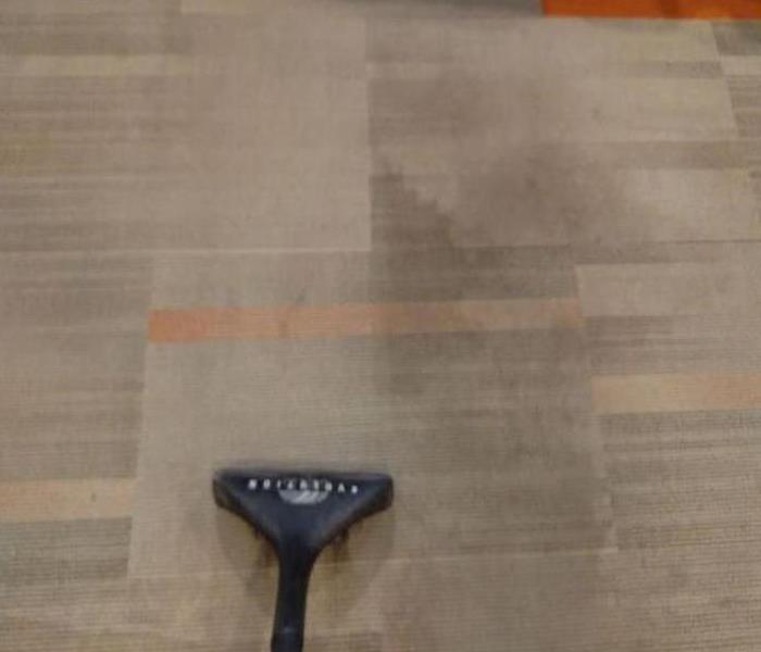 visible fall out and soot on carpeting that has been halfway removed by SERVPRO 