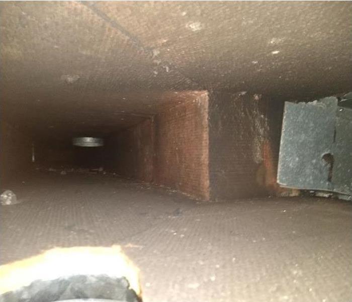 Interior of a home's duct work covered in soot from a recent fire. 