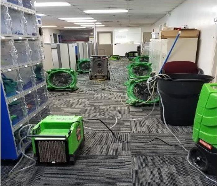 Business office with lots of drying equipment drying carpeting. 