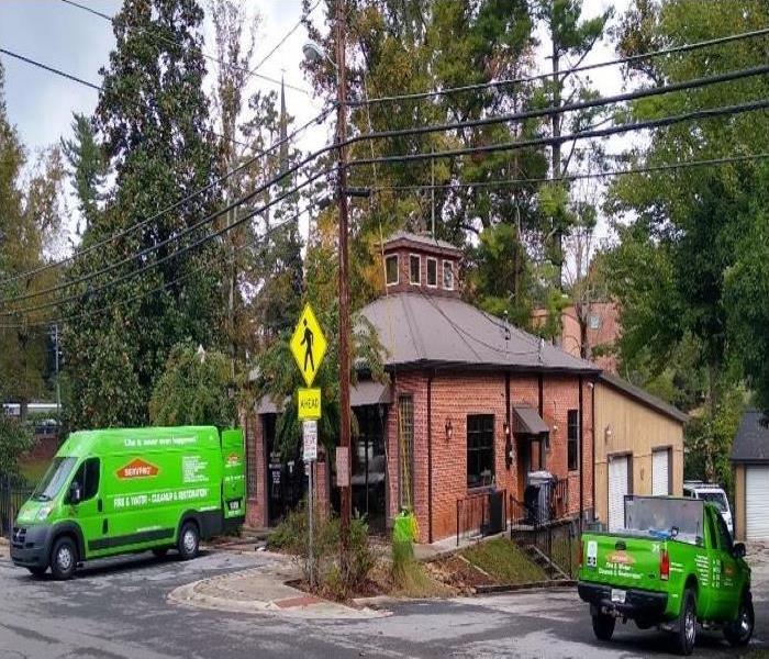Brick police station with 2 SERVPRO vehicles out front